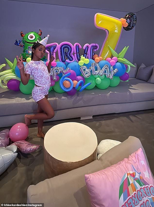 She shared photos of True posing alongside an extravagant display of balloons before heading to her birthday party