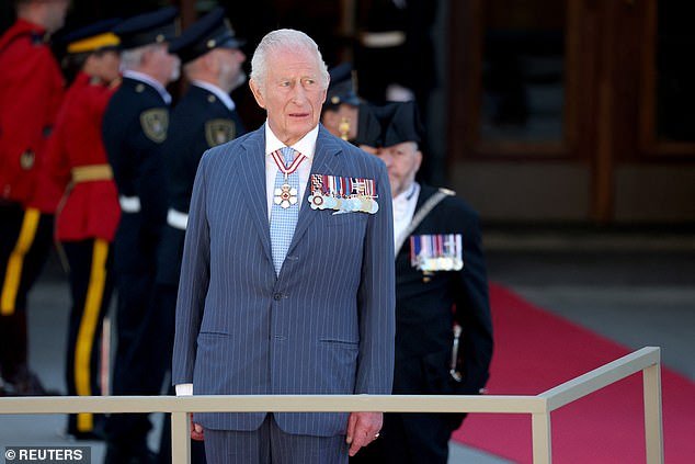 The King stood outside the Senate of Canada Building while a band played the Canadian national anthem
