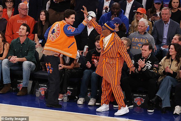 Timothee Chalamet celebrates with Spike Lee during the first quarter of Thursday's win