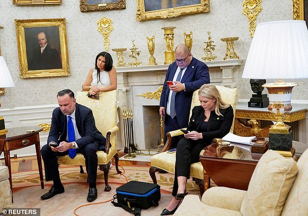 Pictured right to left: Katie Miller and Stepehen Miller,White House Communications Director Stephen Cheung and White House Press Secretary Karoline Leavitt look at their phones