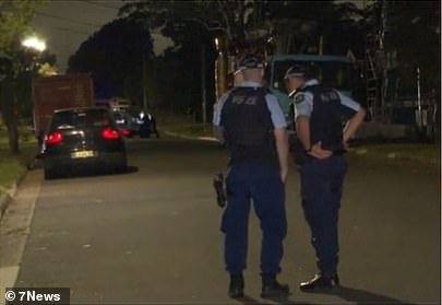 Officers are seen outside the home following the drive-by shooting