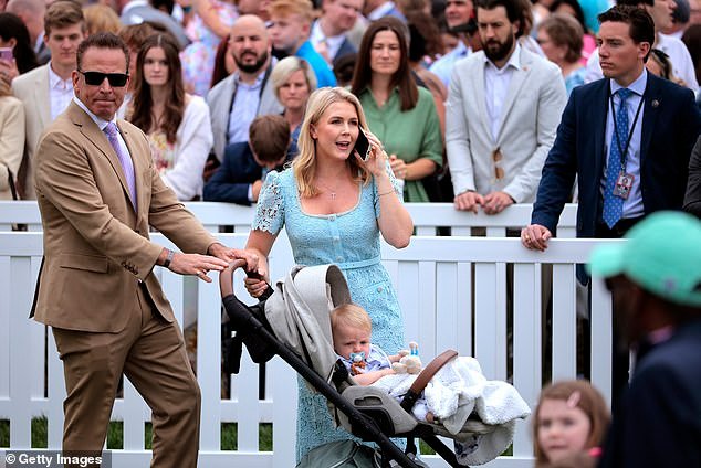 White House press secretary Karoline Leavitt balances double duty: on the phone for work while with son Niko and husband Nicholas Riccio at the White House Easter Egg Roll