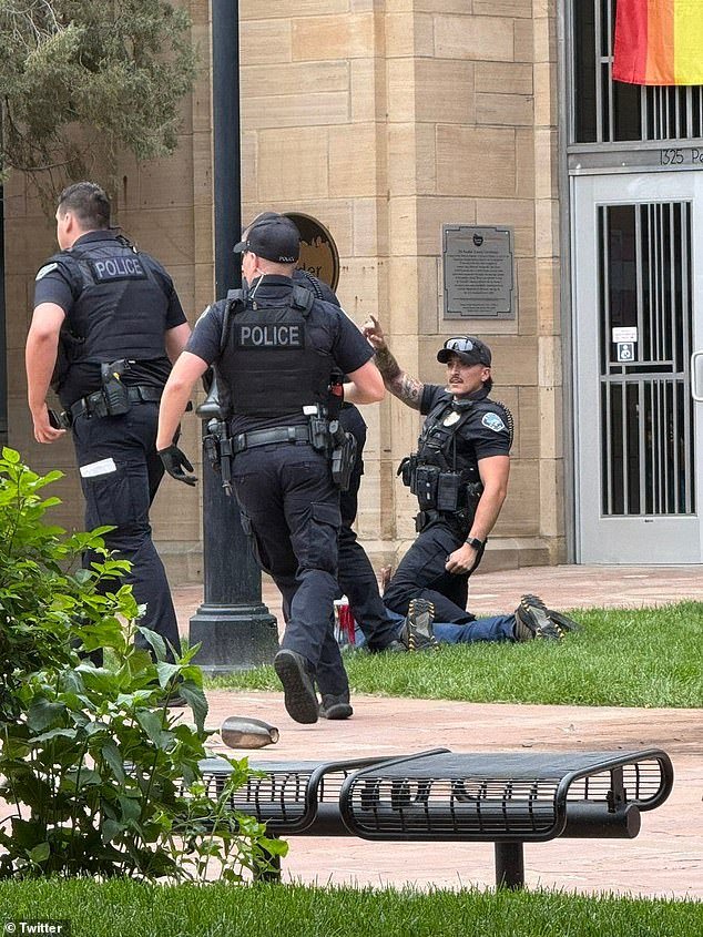 Eyewitness Brooke Coffman said she saw 'a big fire go up' at the scene, prompting her to call 911. (Pictured: Police detaining the suspect at the scene)