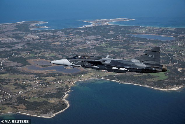 A Swedish JAS 39 Gripen E fighter jet flies over Sweden's Gotland island in the Baltic Sea