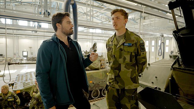 Gotland is increasing the number of conscripts it trains each year as the country ramps up militarisation. MailOnline's Chief Foreign Reporter David Averre is pictured speaking with a conscript named Ivar