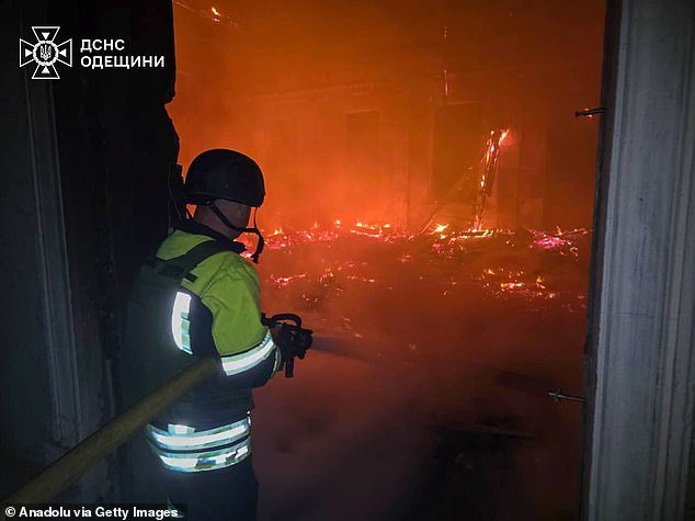 Ukrainian search and rescue teams and local fire brigades work at the scene of a strike