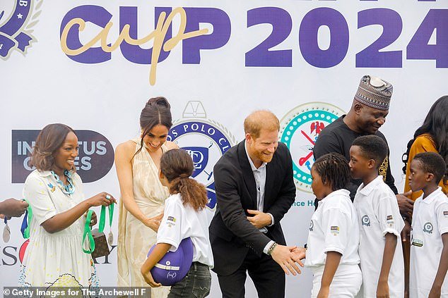 Meghan and Harry greet children on their visit to the Polo Club on May 12, 2024 in Lagos