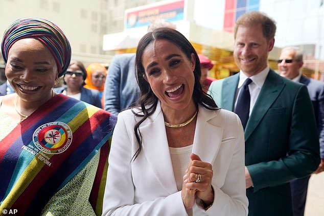 Harry and Meghan speak to military wives at the Defence Headquarters in Abuja on Friday
