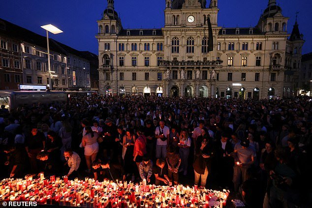 Today, a nationwide minute's silence will be held at 10am local time. Flags on the Hofburg Palace in Vienna, where the president has his office, will fly at half mast. Pictured: People light candles in the main square