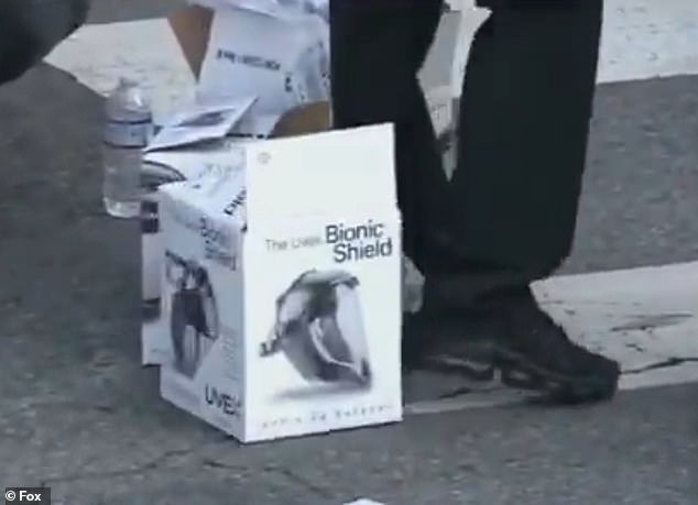 The group passed out 'bionic shield' branded masks to a large crowd of demonstrators near the federal buildings in downtown LA on Tuesday