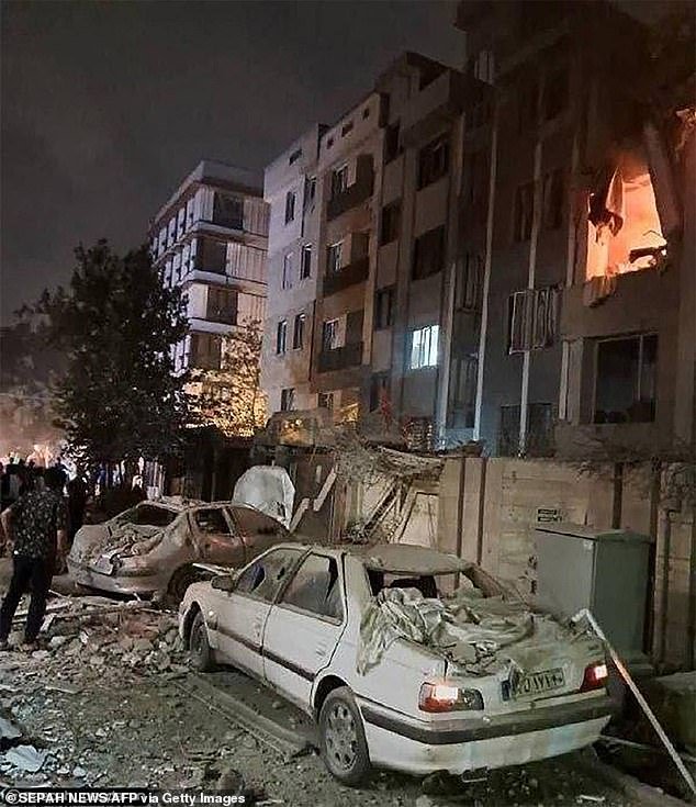 This handout photo released by Iran's Revolutionary Guard Corps reportedly shows a building in Tehran hit in an Israeli strike on the Iranian capital early in the morning