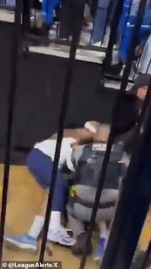 At one point, the four-time NBA All-Star is thrown to the floor as fans continue to throw drinks at him