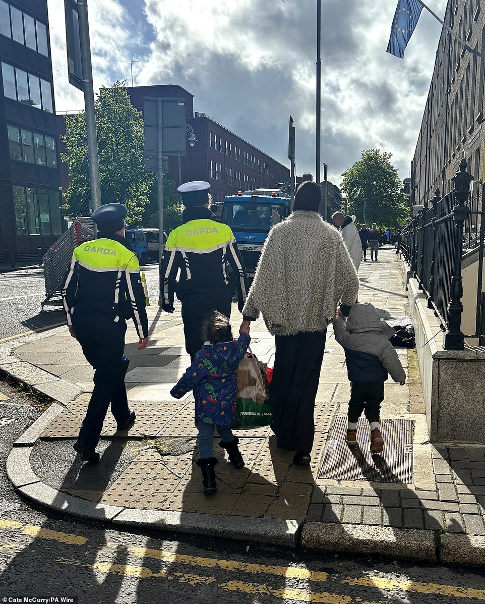 Justice Minister Helen McEntee, who recently alleged that more than 80% of migrants in Ireland are coming in via Northern Ireland to avoid deportation to Rwanda, said that the government must ensure a tent city does not return. 'Once people are moved, measures will be put in place to ensure that it doesn't happen again. 'When they are provided with that accommodation, it's also really important that we don't see scenes like we're seeing now at Mount Street again, that it cannot re-emerge, that we have hundreds of tents ¿ not just outside the international protection office ¿ but outside people's homes, outside people's businesses.' Deputy Irish premier Micheal Martin said this morning's operation was to ensure the 'safe movement of people' who are seeking asylum, but warned that the government would not let the tents return.