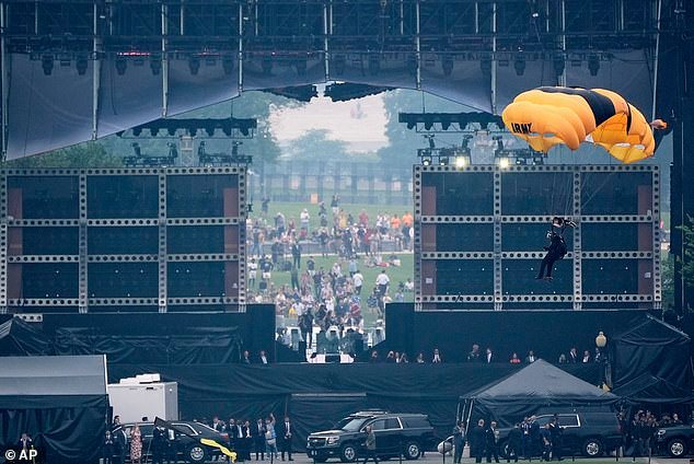 A member of the U.S. Army Parachute Team Golden Knights makes their landing behind the viewing stand on the Ellipse during the Army's 250th birthday parade. Other flyovers took place over the Washington Monument