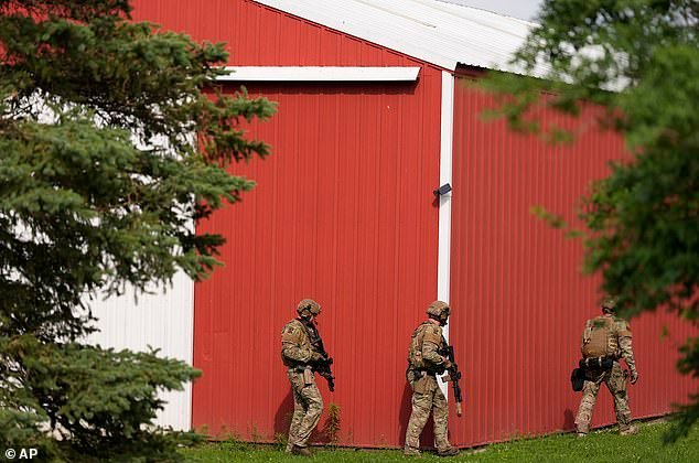 Camouflaged law enforcement agents carefully swept the area
