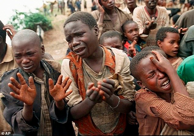 Rwandan refugee children plead with Zairean soldiers to allow them across a bridge separating Rwanda and Zaire where their mothers had crossed moments earlier before the soldiers closed the border, in Zaire, now known as Congo, August 20, 1994
