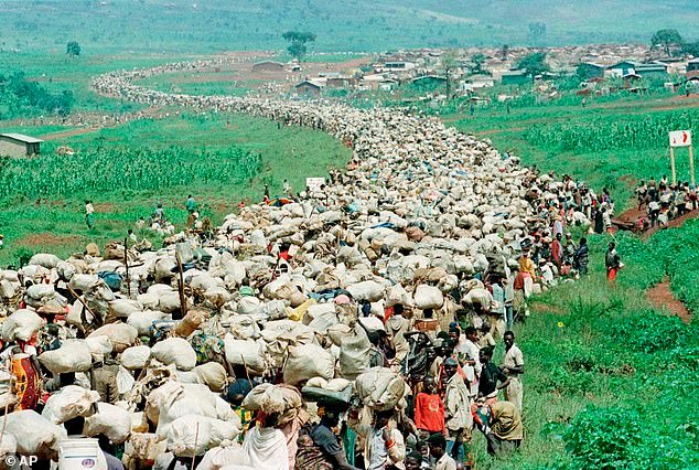 Tens of thousands of Rwandan refugees, who have been forced by the Tanzanian authorities to return to their country despite fears they will be killed upon their return, stream back towards the Rwandan border on a road in Tanzania, December 19, 1996