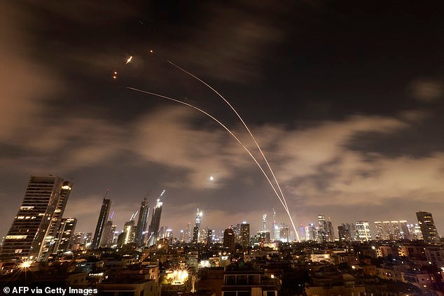 Israeli air defense systems were activated to intercept Iranian missiles over Tel Aviv early on Wednesday