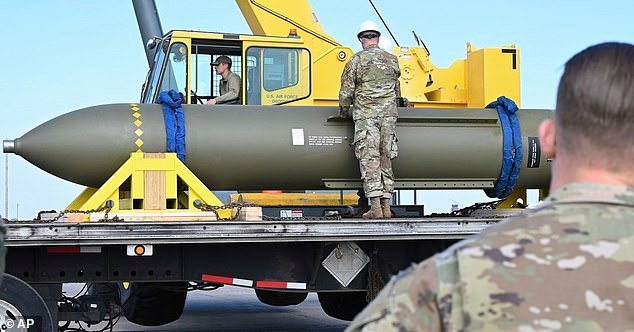 In this photo released by the U.S. Air Force on May 2, 2023, airmen look at a GBU-57, or the Massive Ordnance Penetrator bomb, at Whiteman Air Base in Missouri