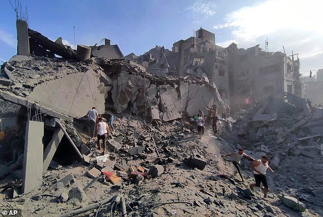Palestinians inspect the damage of buildings destroyed by Israeli airstrikes on Jabaliya refugee camp on the outskirts of Gaza City, Tuesday, Oct 31, 2023