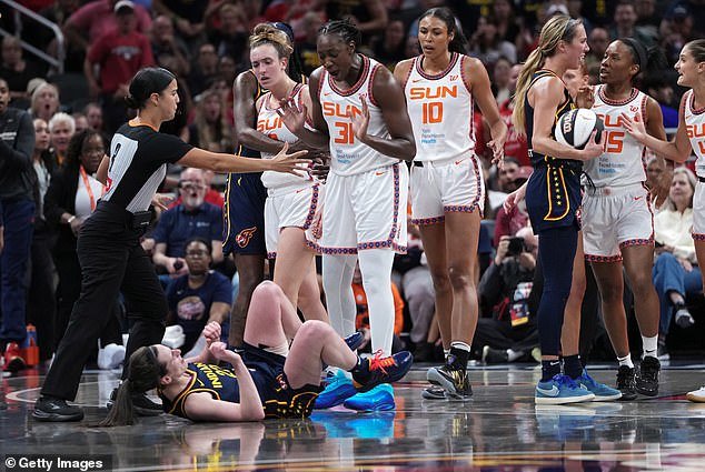 Caitlin Clark was shoved to the ground by Marina Mabrey (left) versus the Sun, after being poked in the eye by Jacy Sheldon (far right)