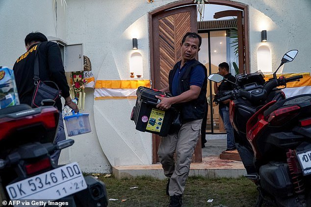 Bali detectives fear the gunmen went straight to the nearby airport and fled overseas (pictured, officers at the scene)