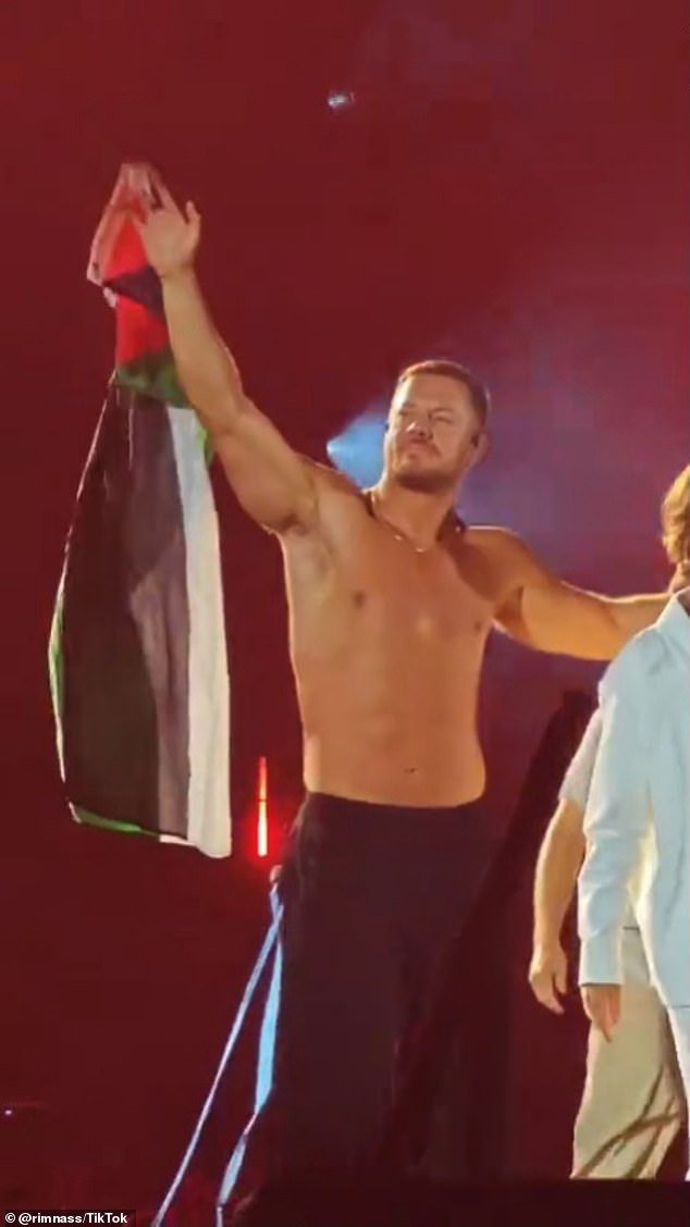 Imagine Dragons is facing backlash after frontman Dan Reynolds (pictured) waved a Palestinian flag on stage during a recent concert in Milan