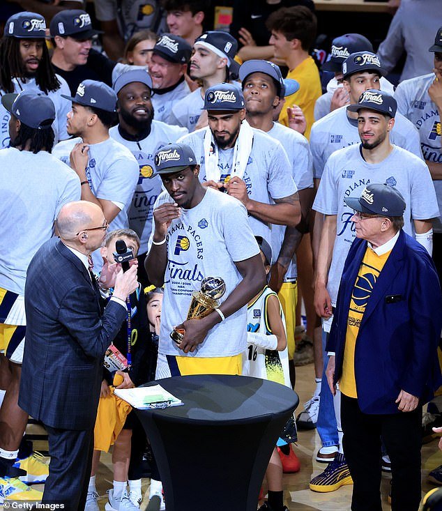 Siakam receives the MVP trophy as Haliburton (far right) is seen smirking towards the crowd