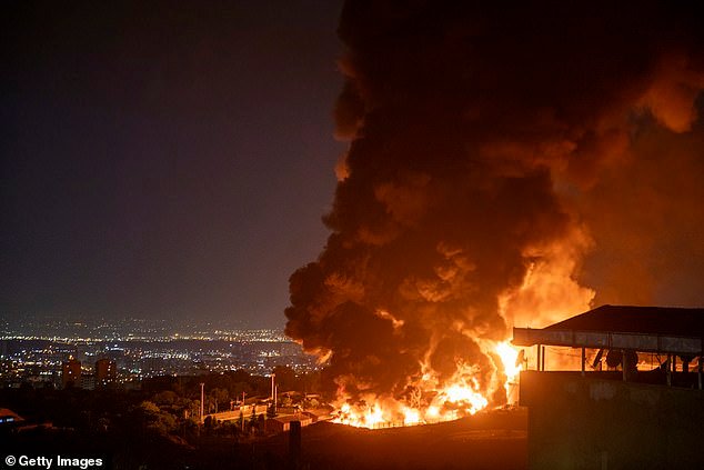 Los Angeles cops have scrambled to delete a bizarre social media post about the conflict in Iran after it was widely slammed as 'embarrassing' and 'offensive'. (Pictured: Fire and smoke rise into the sky after an Israeli attack on the Shahran oil depot on June 15, 2025 in Tehran)