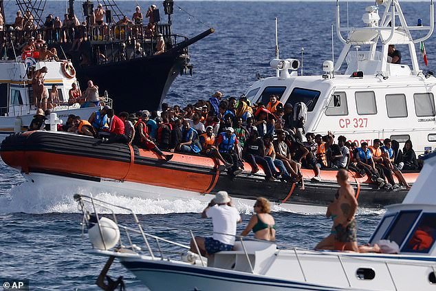 Migrants being brought ashore on the Italian island of Lampedusa