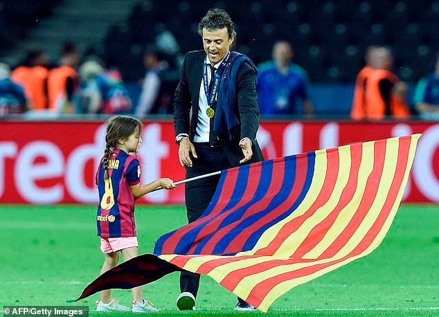 Xana plants a Barcelona flag in centre circle after her father won the 2015 Champions League