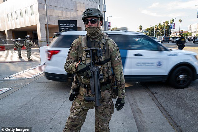 Federal agents guard outside of a federal building and Immigration and Customs Enforcement (ICE) detention center on June 13, 2025, in Los Angeles, California
